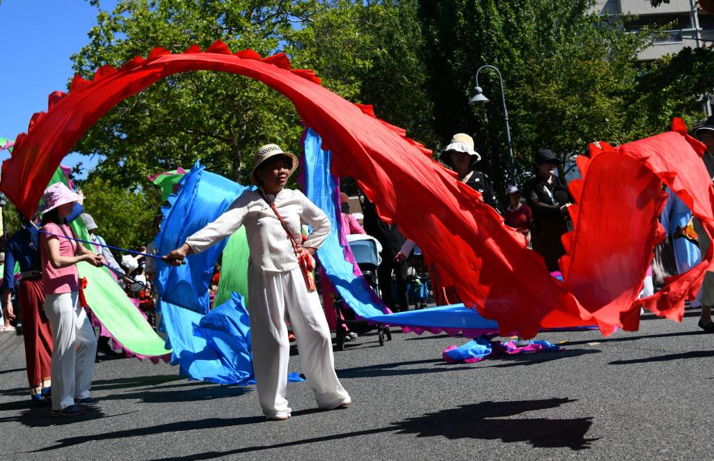 Members of the Mercer Island Chinese Association bring a colorful touch to the Mercer Island Summer Celebration downtown parade on July 12. The all-day event also featured live entertainment, art and food vendors, fireworks, interactive booths, games, opportunities to meet city departments and explore equipment and more. Activities took place at Mercerdale Park and Luther Burbank Park with a fireworks show blasting off at Luther Burbank Park at 10 p.m. Andy Nystrom/ staff photo