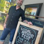 Island Books bookseller Brad Beshaw stands in front of the shop on July 15. Andy Nystrom/ staff photo