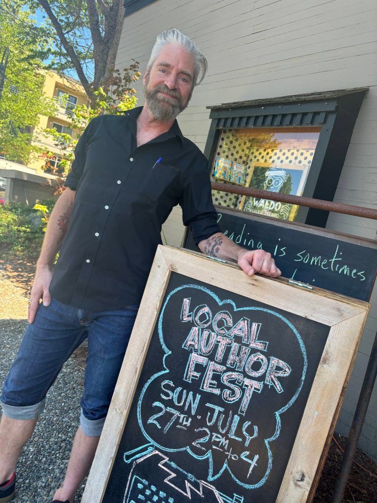 Island Books bookseller Brad Beshaw stands in front of the shop on July 15. Andy Nystrom/ staff photo