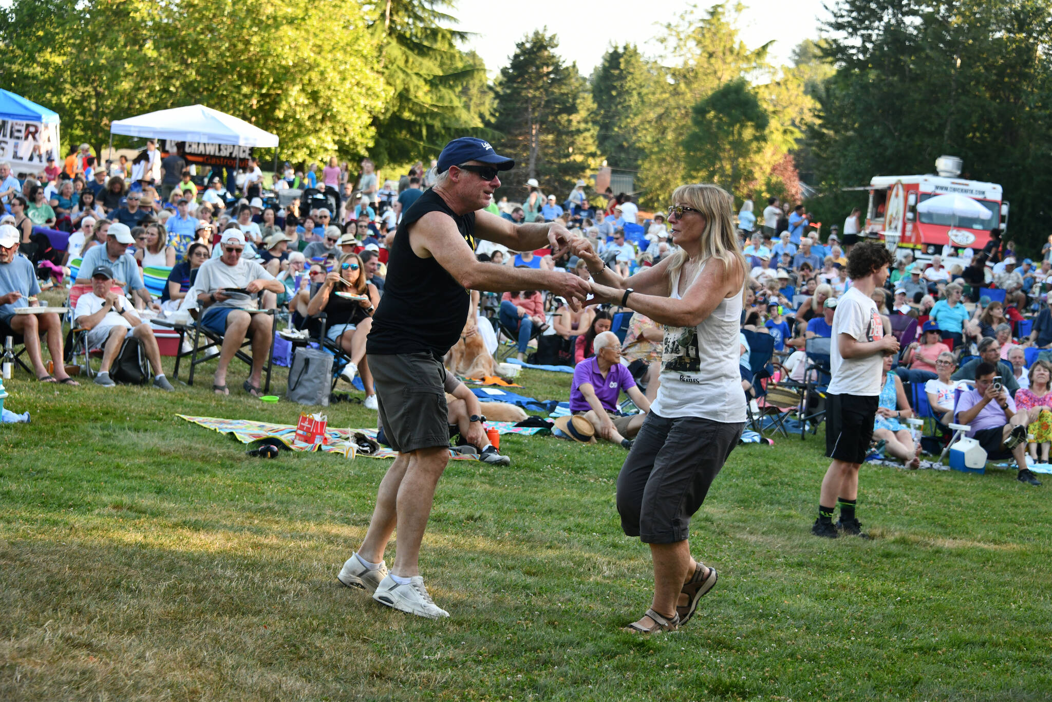 Dancers groove to the sounds of Paperback Writer, a Beatles tribute band, on July 17 at Mercerdale Park. Andy Nystrom/ staff photo