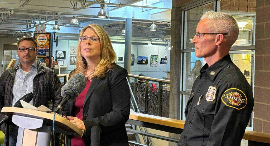 Mercer Island City Manager Jessi Bon addresses the media on April 4, 2024, regarding a leaking underground water pipe that posed a landslide risk to a section of the city on April 3, 2024. Joining her at the press conference  which occurred at the Mercer Island Community Event Center  are, at left, Seattle Public Utilities Wylie Harper, and at right, Eastside Fire Rescue Chief Ben Lane. Andy Nystrom/ staff photo