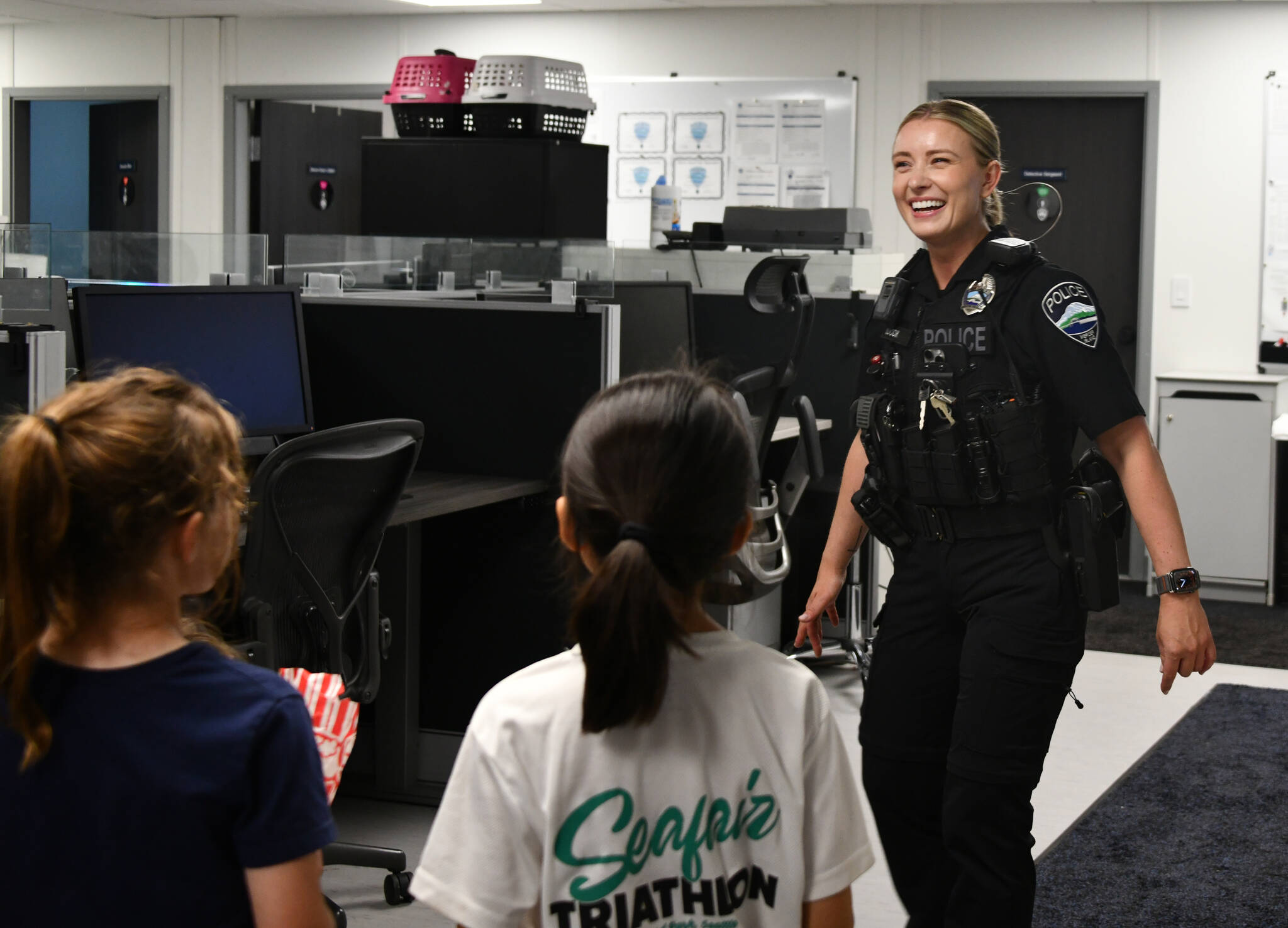 Mercer Island Police Department patrol officer Marina Udodik leads a tour of the departments modular buildings on Aug. 5 at the citys National Night Out event at the city hall parking lot. Andy Nystrom/ staff photo
