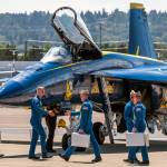 Blue Angels pilots return to the tarmac at Boeing Field after their flight, carrying flight gear bags holding helmets, oxygen masks, and other essentials. Photo courtesy of Andrew Meade