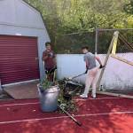 Mercer Island High School football players Eshaan Pastel and CJ Greenfield participate in a school field cleanup day on Aug. 1. Courtesy photo