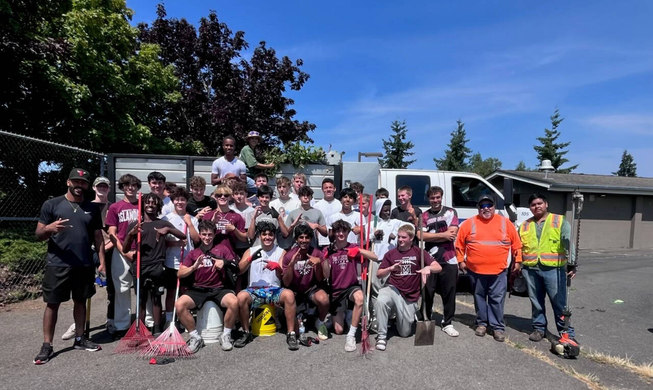Mercer Island High Schools football players banded together in a school field cleanup day on Aug. 1. Also lending a hand were coaches, parents, Mercer Island School District facilities director Tony Kuhn and Plantscapes members. Courtesy photo