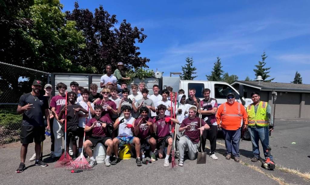 Mercer Island High Schools football players banded together in a school field cleanup day on Aug. 1. Also lending a hand were coaches, parents, Mercer Island School District facilities director Tony Kuhn and Plantscapes members. Courtesy photo