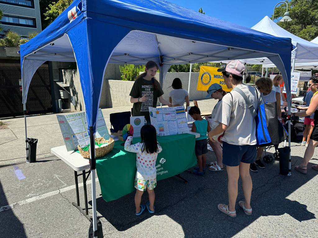 Mercer Islands Kate deStwolinski provides sun safety education at her Summer Celebration booth last month. Courtesy photo