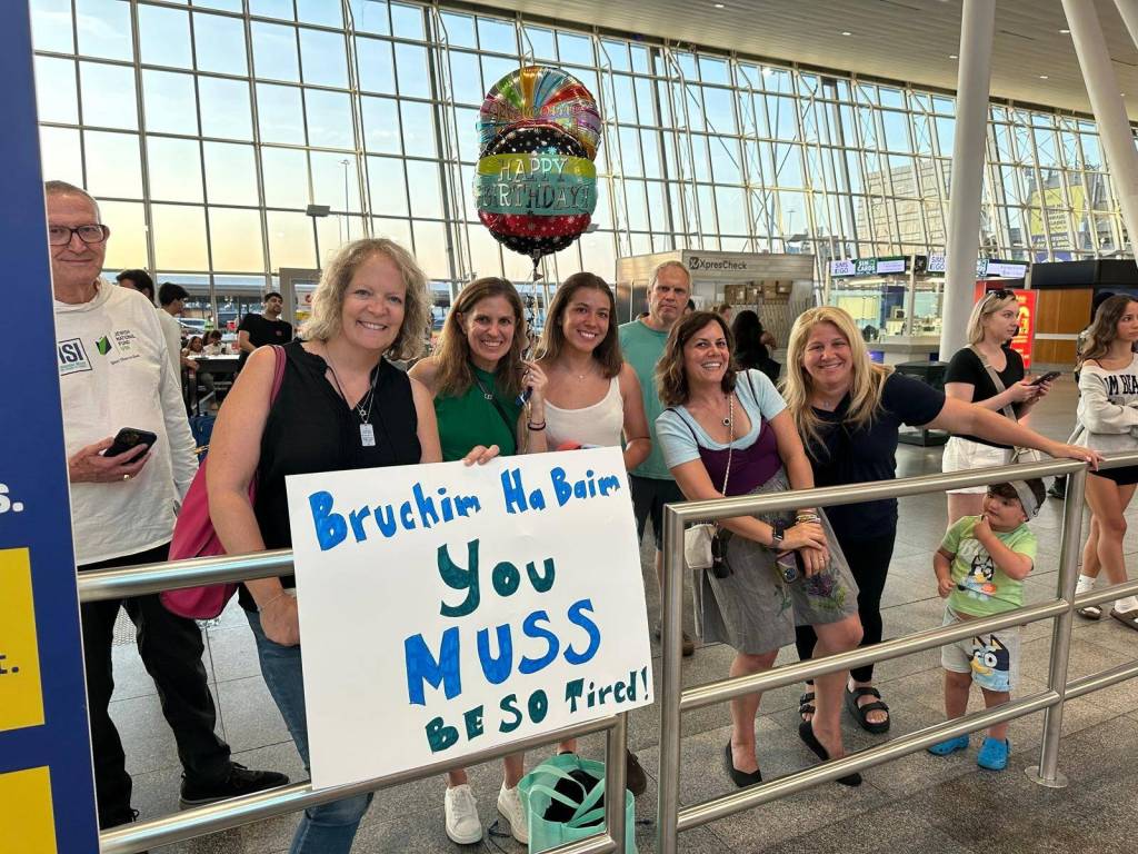Students reunited with their parents at JFK International Airport. Photo courtesy of JD Krebs