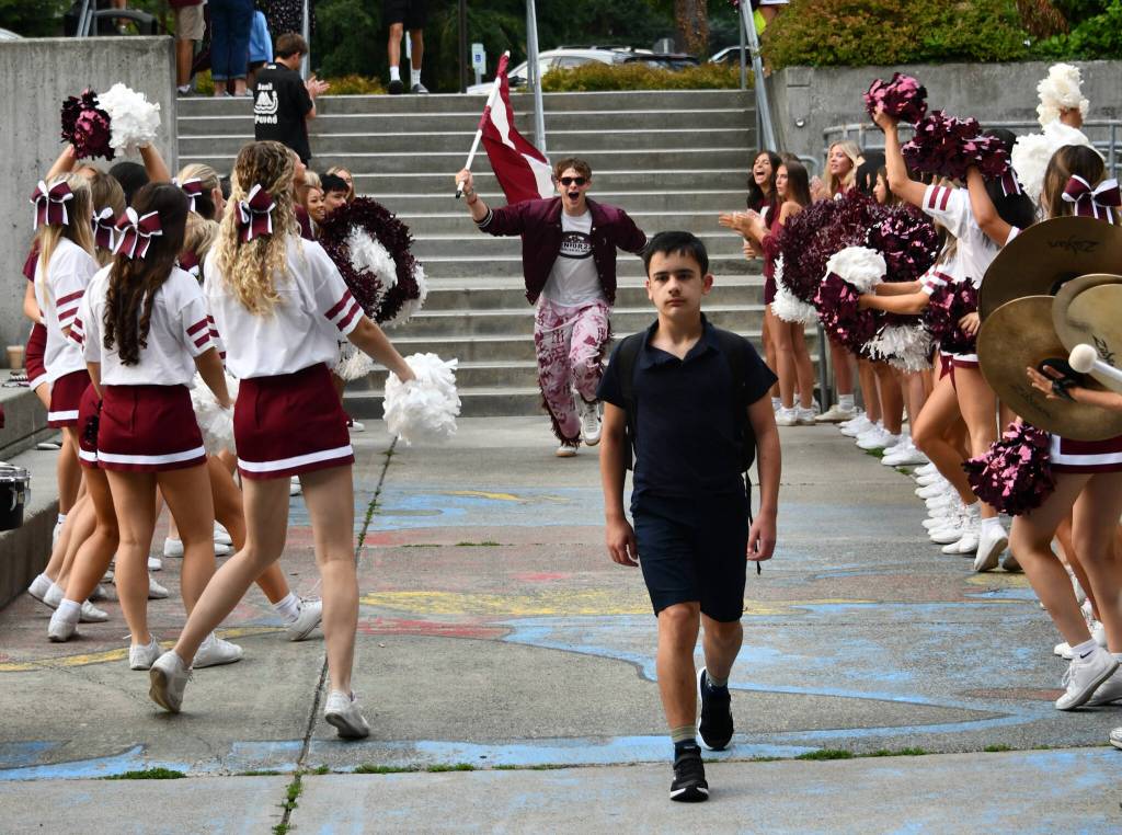 Members of the Mercer Island High School drill team, cheer squad and the drum corps along with other students welcome ninth-graders onto campus on the first day of school on the morning of Aug. 27. An orientation assembly followed the festive greeting. Andy Nystrom/ staff photo