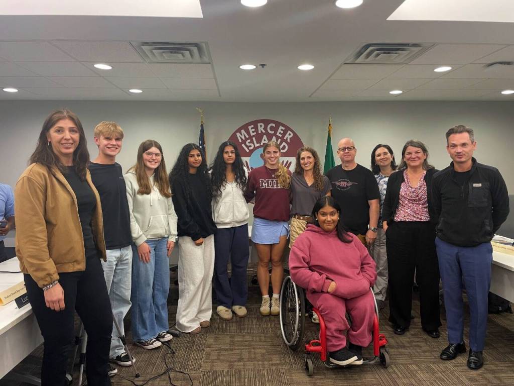 Members of the MIHS 3A state champion girls track and field team with the Mercer Island School Board. Photo courtesy of MISD