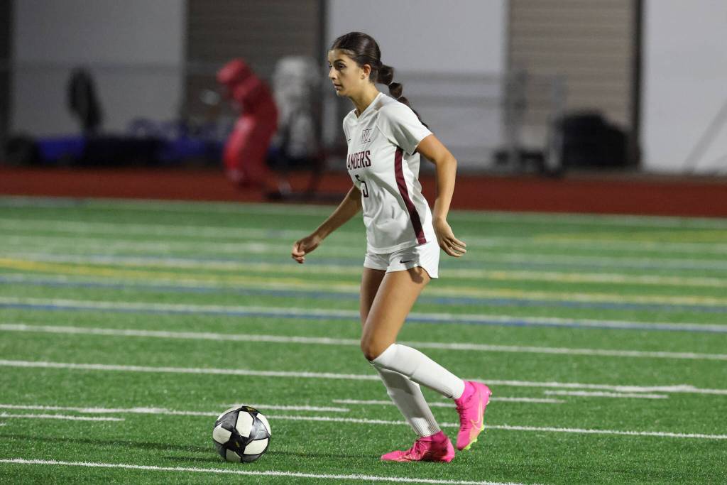 Mercer Island High School senior Anna Mock dribbles the ball up field. Photo courtesy of Rick Edelman