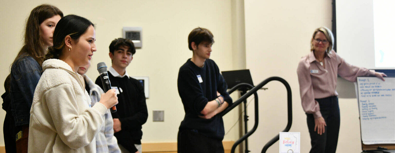 At left, Mercer Island High School student Sophie Hill speaks to the crowd at the MI Healthy Youth Forum on Jan. 31, 2024, at the Mercer Island Community and Event Center. Also pictured are students Savanna Rousell, Julius Perez and Connor Wood along with Michelle Ritter, Mercer Island Healthy Youth Initiative project coordinator. Andy Nystrom/ staff photo