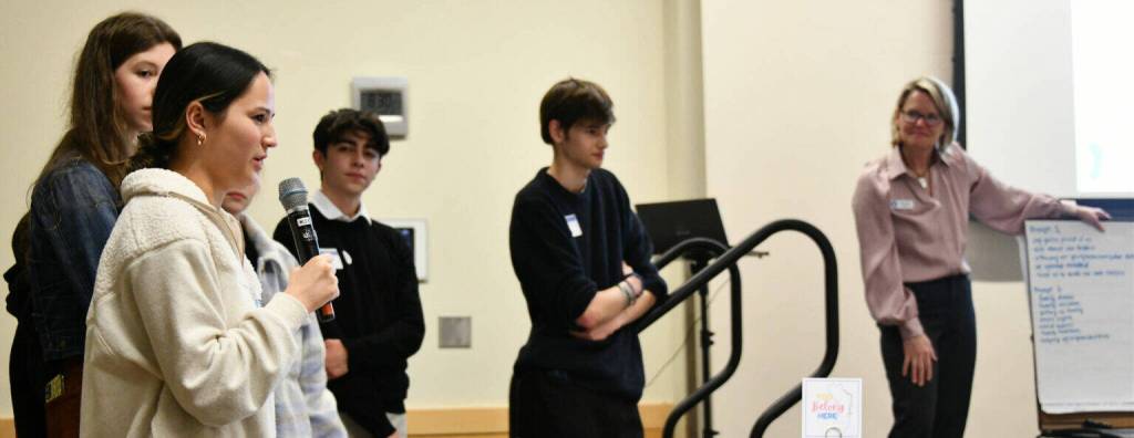 At left, Mercer Island High School student Sophie Hill speaks to the crowd at the MI Healthy Youth Forum on Jan. 31, 2024, at the Mercer Island Community and Event Center. Also pictured are students Savanna Rousell, Julius Perez and Connor Wood along with Michelle Ritter, Mercer Island Healthy Youth Initiative project coordinator. Andy Nystrom/ staff photo