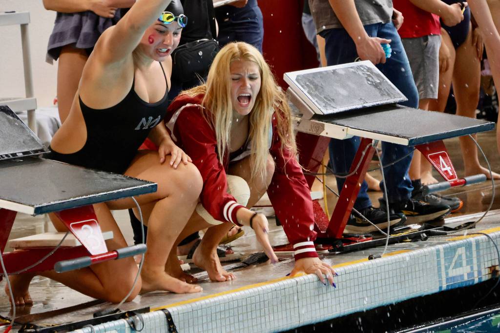 Mercer Island High School junior Emma Morelli and senior Maya Moncaster cheer on their teammates. Photo courtesy of Kara Lucas