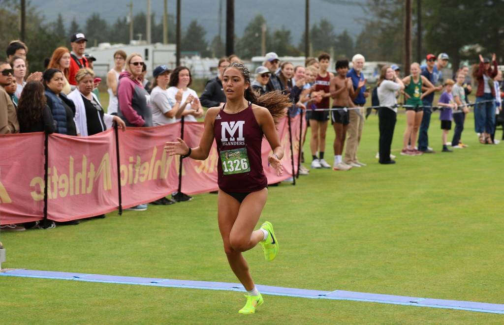 Mercer Island High School junior Sophia Rodriguez crosses the finish line in first place with the fastest 5,000-meter girls cross country time in the nation with a personal record of 16:10 on Sept. 20 at the Mook XC Invite at Alderbrook Golf Course near Tillamook, Oregon. She also set the course record and broke the Washington state record. Photo courtesy of Scott Knoblich