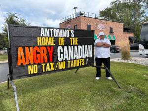 The sign outside Antoninos Pizza in Windsor advertises Angry Canadian pizza. Photo by Mindy Stern