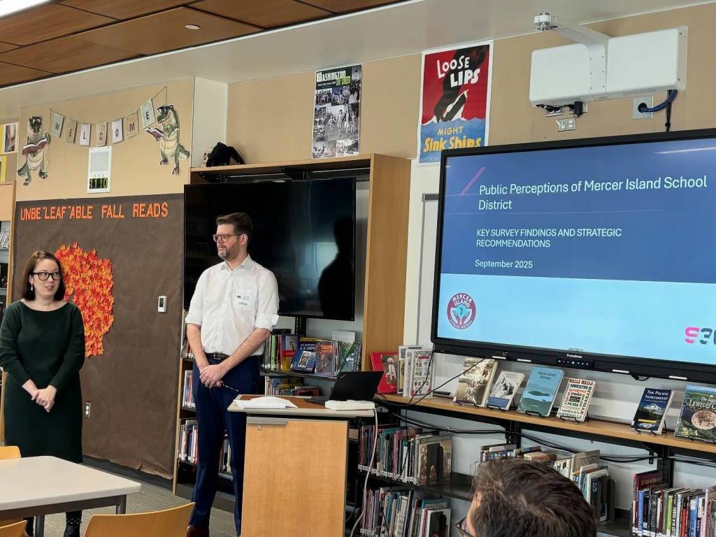 Rachel Nakanishi and David Kornahrens from Strategies 360 present the survey results to the Mercer Island School District board at a special session on Oct. 15 at Islander Middle School. Photo courtesy of the Mercer Island School District