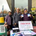 Mercer Island Rising United for Democracy hosted a food and grocery store gift card drive in response to the federal government withholding SNAP funding for two hours on Nov. 14. Generous shoppers at the north end QFC donated more than $1,330 and a carload of groceries and supplies. The gift cards went to Mercer Island Youth and Family Services food security programs, and the food and supplies were given to Hopelink on the Eastside. Pictured are Julie Sarkissian, Callie Ridolfi and Q Galazer. Courtesy photo