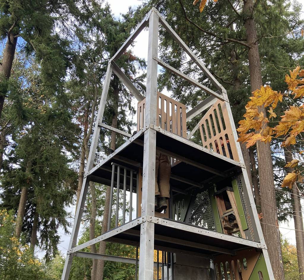 Crews recently began assembling the new Alpha Tower as part of their construction work to install a brand-new playground at First Hill Park. The 20-foot-tall structure, designed for children ages 5-12, features two slides: a double slide for riding two at a time from an eight-foot deck, and a winder slide to ride from a 12-foot deck. Over the past few weeks, crews also poured a concrete slab for the free-play log tunnel; installed posts for new swings; started building a timber curb that will enclose the play area; and began backfilling the enclosure in preparation for an engineered, wood fiber play surfacing. Upcoming work includes pouring a concrete curb at the play area entrance and finishing a timber border. Construction remains on track and is expected to conclude in December. This project is made possible by the parks levy renewal approved by Mercer Island voters in 2022. Photo courtesy of the city of Mercer Island