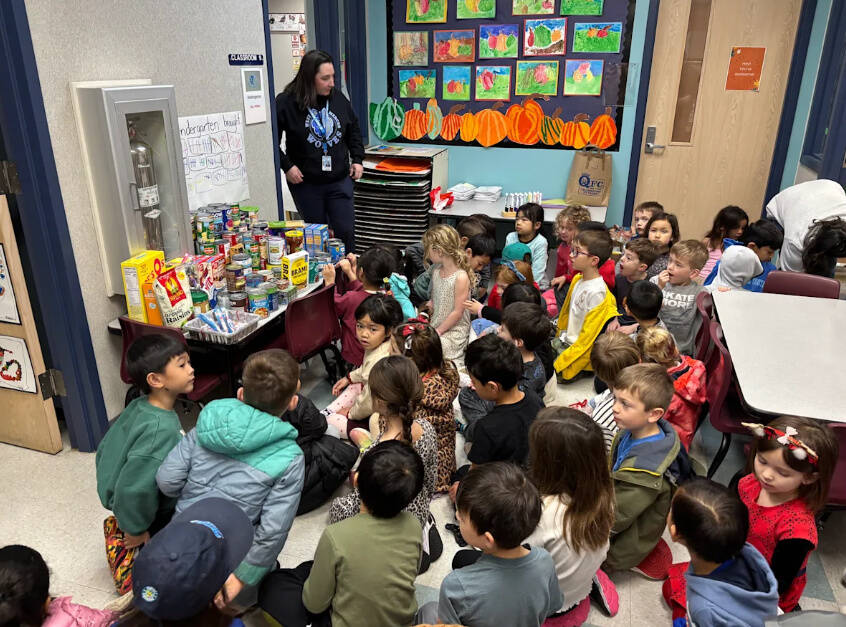 West Mercer kindergarten students looking at the tally sheet of food items collected by their classes. Photo courtesy of the Mercer Island School District