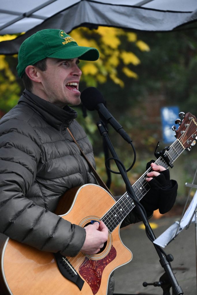 Zach Lombardo performs U2s With or Without You at the Harvest Market. Andy Nystrom/ staff photo