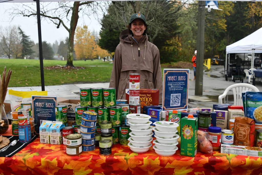 Mercer Island Farmers Market President Emeritus Jennifer Goodrich stands behind the Harvest Share Table at the Harvest Market on Nov. 23. Andy Nystrom/ staff photo