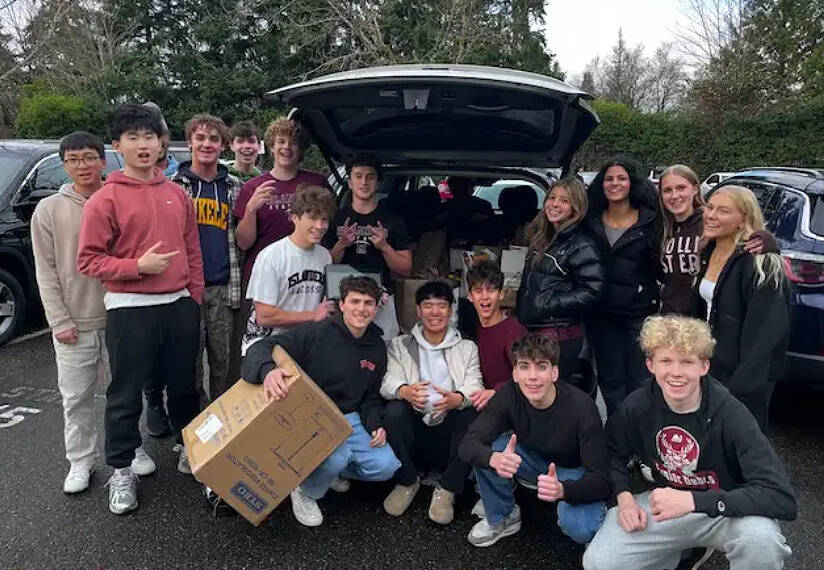 Mercer Island High School AP microeconomics students in a group photo in front of a car loaded with donated food items for the Fall City Food Pantry. Photo courtesy of the Mercer Island School District