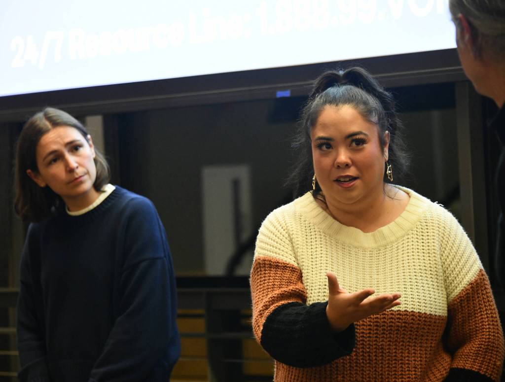 King County Sexual Assault Resource Center prevention services specialist Jessica Cowles, middle, speaks to Director of Prevention & Education Services Chris Johnson as prevention services specialist Hannah Pepin listens. Andy Nystrom/ staff photo