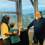 The Friendship Circle of Washington, which is based on Mercer Island, held a menorah lighting, Chanukah celebration and festivity on Dec. 14 at the Mercer Island Community and Event Center. Pictured is Mathew, 16, lighting the menorah as a volunteer and Rabbi Elazar Bogomilsky watch. Also pictured below is a performer in the outdoor entertainment light show. In a letter to the editor to the Mercer Island Reporter , Rabbi Bogomilsky said, in part: As we light the first candle, lets hold in our hearts the holy souls who perished in Bondi Beach, and send prayers for healing and a speedy recovery to all who are injured and hurting. Photos courtesy of Marina Prossin