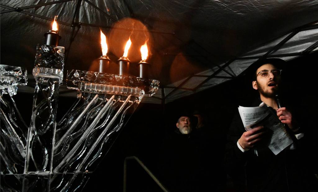 Rabbi Nissan Kornfeld of Chabad Mercer Island addresses the crowd after lighting the ice menorah on Dec. 16 at Mercerdale Park. Andy Nystrom/ staff photo
