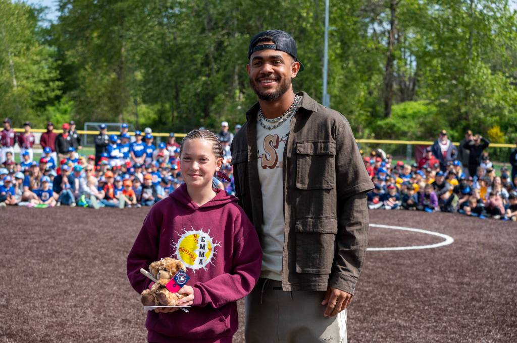 Seattle Mariners center fielder Julio Rodriguez made a surprise visit at the Mercer Island Little League 20th anniversary opening day celebration on April 26 at South Mercer Baseball Fields. Heres J-Rod pictured with one of the home run derby winners, Emma Christofferson from Coast Softball. Courtesy photo