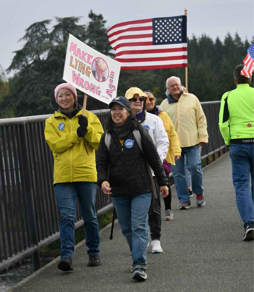 Mercer Island No Kings March participants walk across the Interstate 90 bridge coming from Aubrey Davis Park on Mercer Island on the morning of Oct. 18. Andy Nystrom/ staff photo