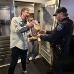 Mercer Island Police Department (MIPD) officer Todd Roggenkamp makes a DoorDash delivery on Jan. 2. During a traffic stop, officers arrested a delivery driver on an outstanding warrant, leaving a dinner order without a driver. Not giving it a second thought, our officers completed the delivery to some very happy residents, MIPD said. Photo courtesy of the Mercer Island Police Department