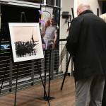 People gather while looking at photos at the memorial. Andy Nystrom/ staff photo