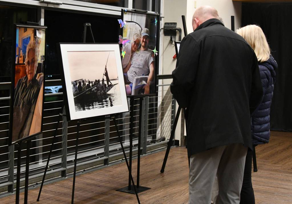 People gather while looking at photos at the memorial. Andy Nystrom/ staff photo