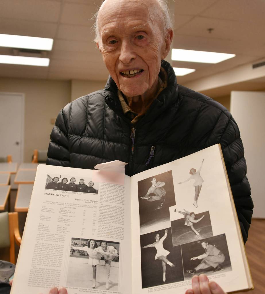 Peter Kennedy displays his 1952 Winter Olympics yearbook, which features a photo of him and his sister Karol, bottom left. Andy Nystrom/ staff photo