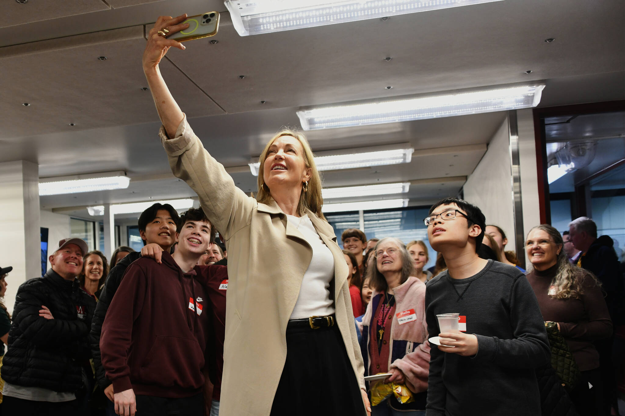 Mary Wayte, 1984 Olympic gold medalist swimmer, takes a selfie with the crowd at the Mary Wayte Pool Renovation Celebration on Jan. 30. Andy Nystrom/ staff photo