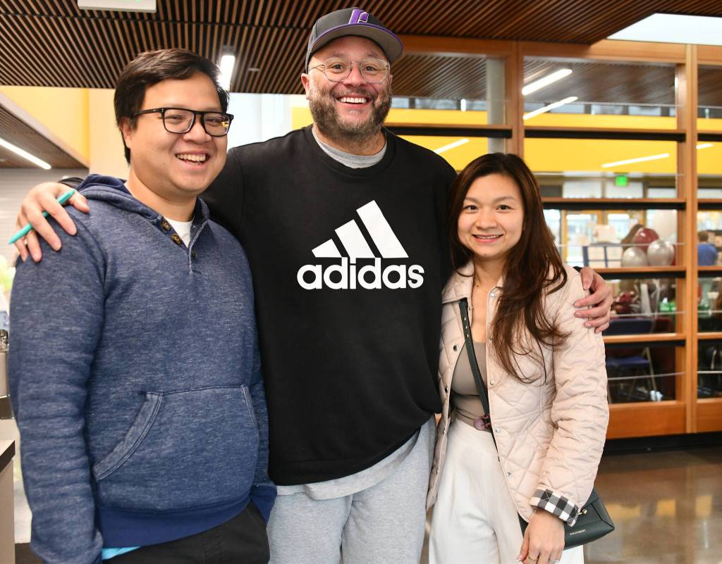 From left, Khang Doan, Brett Chapman and Ha Thai gather at the Mercer Island Preschool Association (MIPA) Preschools and Activities Fair. Thai is the MIPA preschool chair. Andy Nystrom/ staff photo