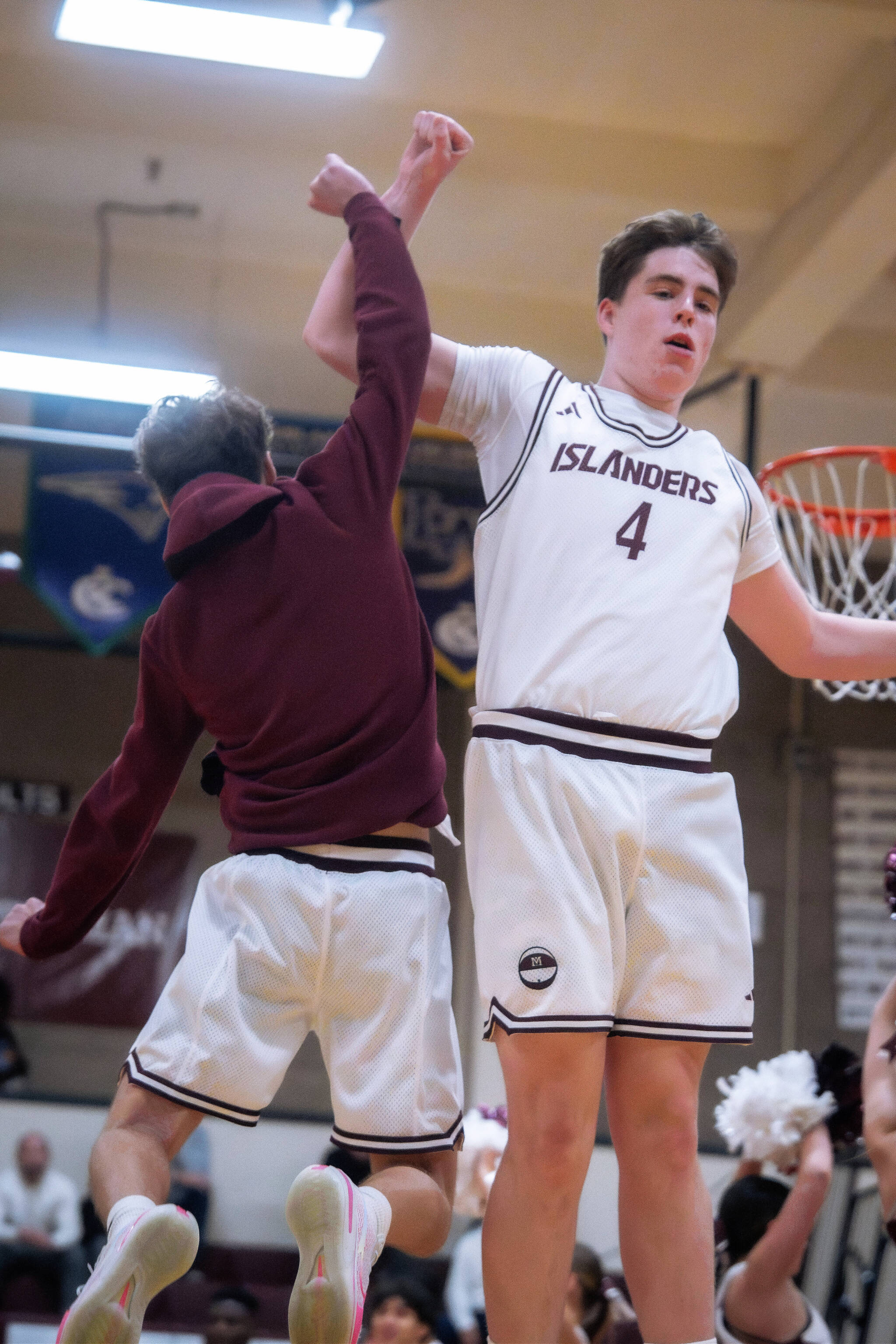 Mercer Island High School junior basketball player Ewan Shea (4) jumps with junior Charlie Friedman at a recent game. Photo courtesy of Ari Stoffer