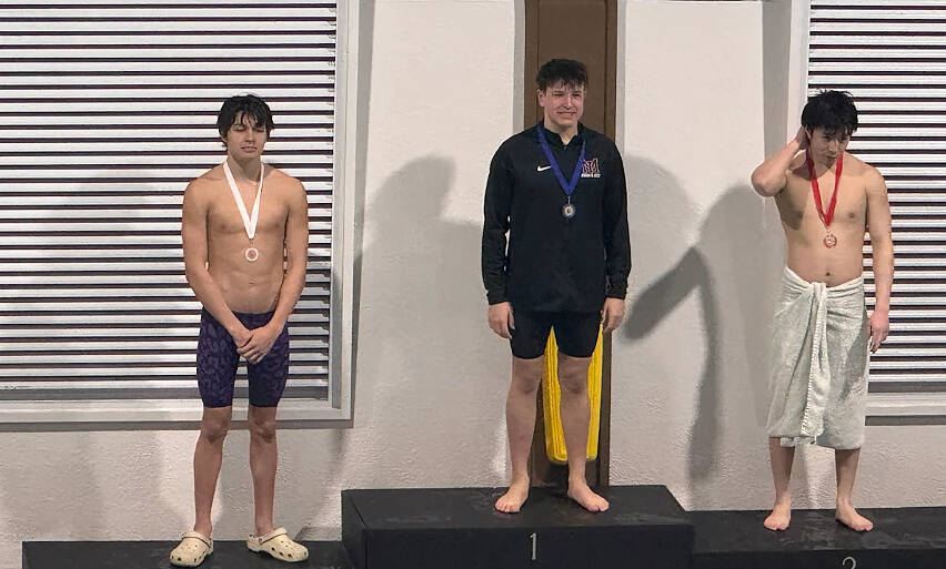 Mercer Island High Schools Luke Dunn (center) stands on the podium at districts after winning the 500 free. Courtesy photo