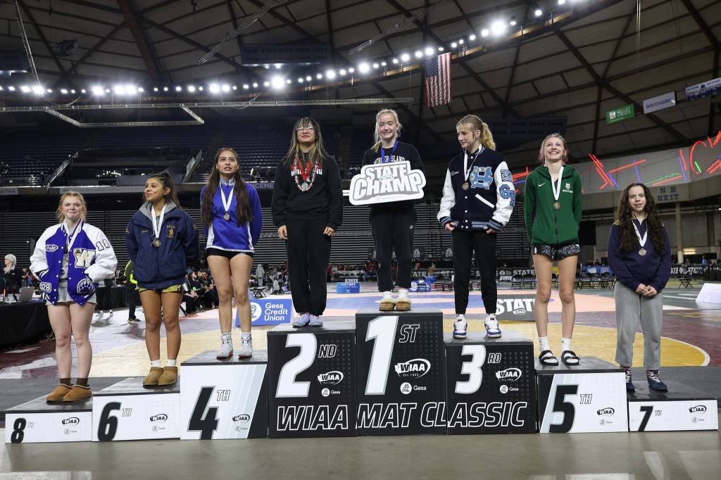 Mercer Island High School sophomore Emerson Woods stands atop the podium after winning the 3A state 110-pound title on Feb. 20 at Mat Classic XXXVII at the Tacoma Dome. Photo courtesy of Colton Knebel