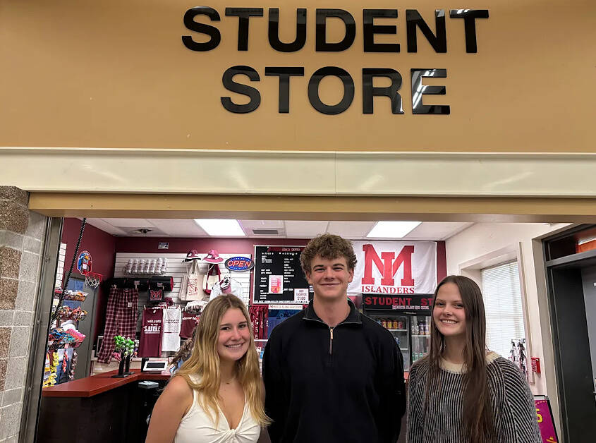 From left to right, Mercer Island High School DECA students Abigail Butson, Duncan Poole and Mattea Skuladottir stand in front of the schools Student Store. Photo courtesy of the Mercer Island School District