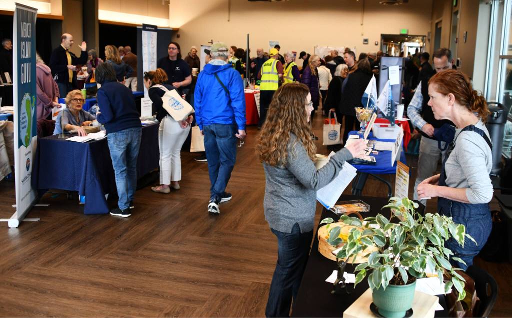 Attendees visit a plethora of booths. Andy Nystrom/ staff photo