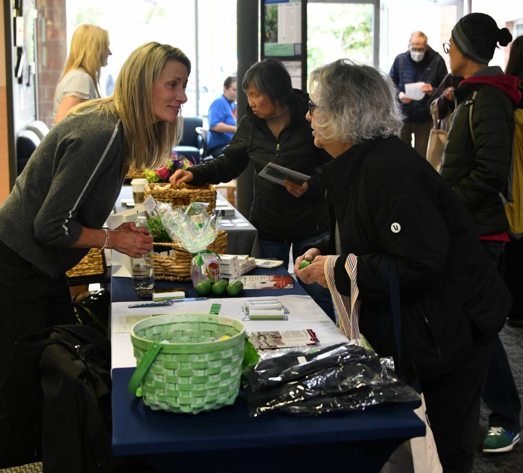 A discussion at the Vineyard Park assisted living booth. Andy Nystrom/ staff photo