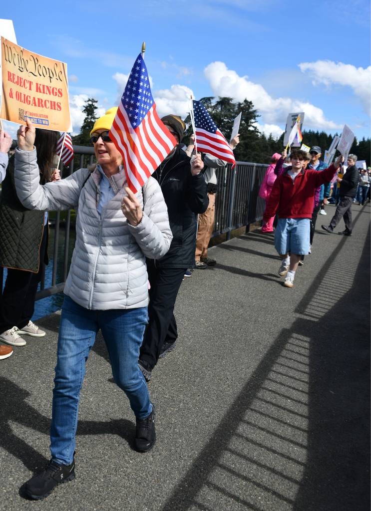 Mercer Island No Kings March participants walk across the Interstate 90 bridge coming from Aubrey Davis Park on Mercer Island on March 28. In a press release, noting that more than 1,200 people attended the march, organizer Gene Robertson said, We have a lot of fun! Mercer Island is a small town, but like everywhere, people are busy. I heard a lot of happy comments about reunions among preschool families, and warm encounters with neighbors. At the front of the park, another organizer enthusiastically stated into a megaphone: Welcome to No Kings Mercer Island! Its a beautiful day for a protest! The No Kings marches are sponsored nationwide by Indivisible to protest the undemocratic conduct of the Trump administration, reads the press release. Andy Nystrom staff photo