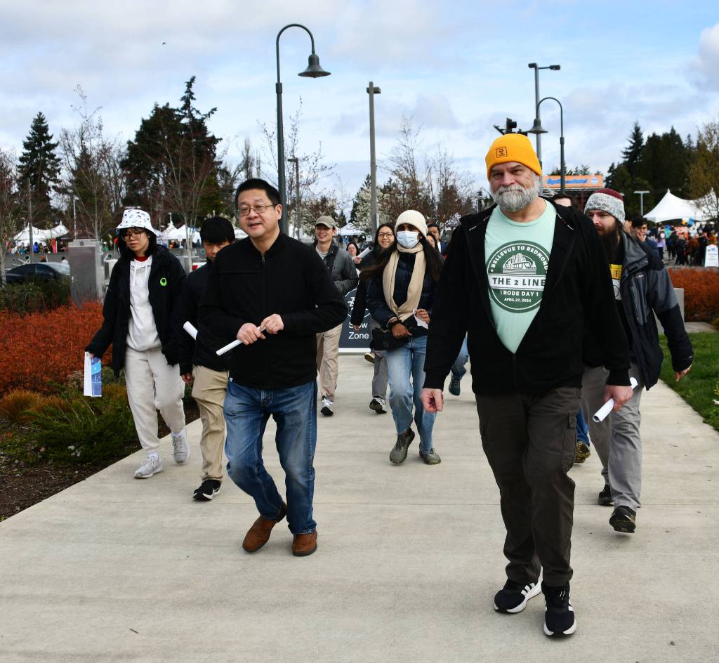 People hurry to the Mercer Island Station on March 28 to take some of the first light rail trips from the Island. Andy Nystrom/ staff photo