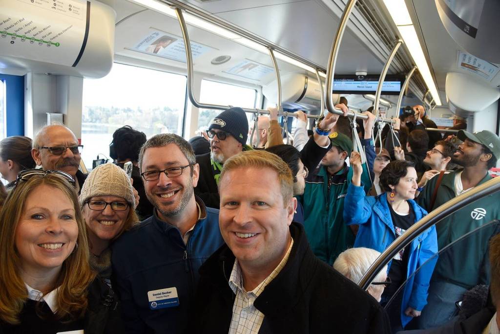 From left, Mercer Island City Manager Jessi Bon, councilmember Wendy Weiker, Deputy Mayor Daniel Becker and Mayor Dave Rosenbaum on the packed first train to Mercer Island on March 28. Photo courtesy of the city of Mercer Island