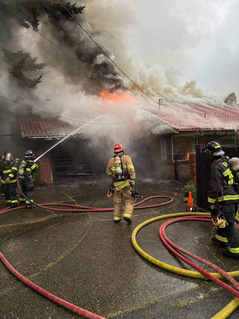 Firefighters work on extinguishing a two-alarm Mercer Island home blaze on April 14. Photo courtesy of Eastside Fire & Rescue