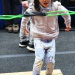 Ella Wai, 5, slingshots a ball at the Baklinski Home Improvement Expert Renovations booth. In the Angry Birds competition, kids try to knock over a stack of boxes with the ball. Andy Nystrom/ staff photo