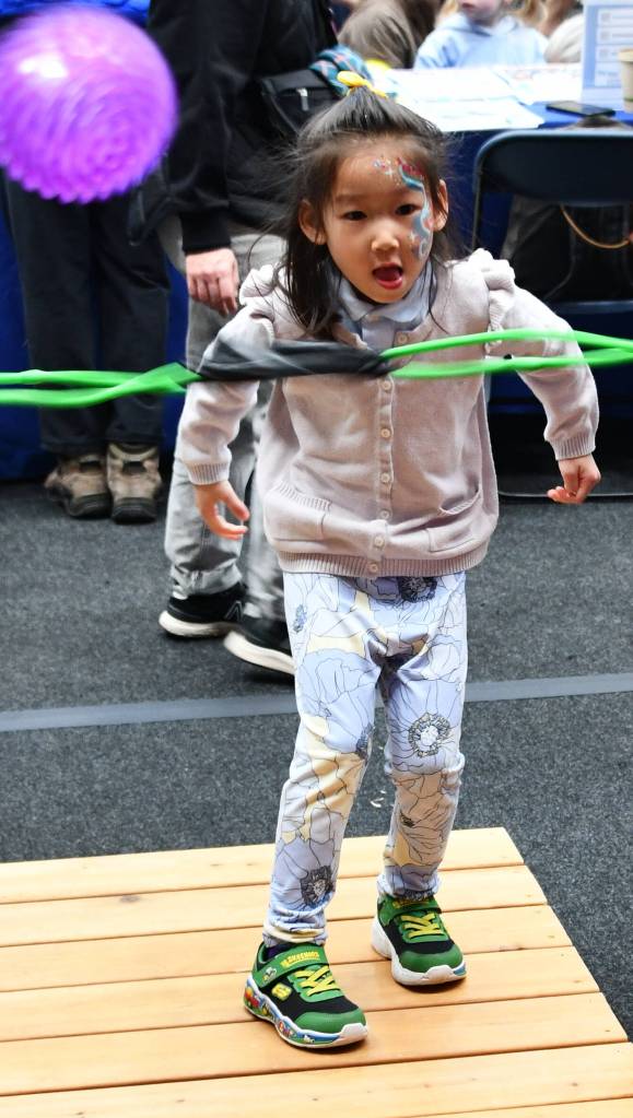 Ella Wai, 5, slingshots a ball at the Baklinski Home Improvement Expert Renovations booth. In the Angry Birds competition, kids try to knock over a stack of boxes with the ball. Andy Nystrom/ staff photo